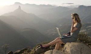 woman sitting outside with laptop